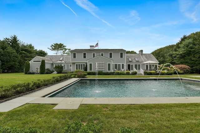 view of swimming pool featuring a lawn and pool water feature