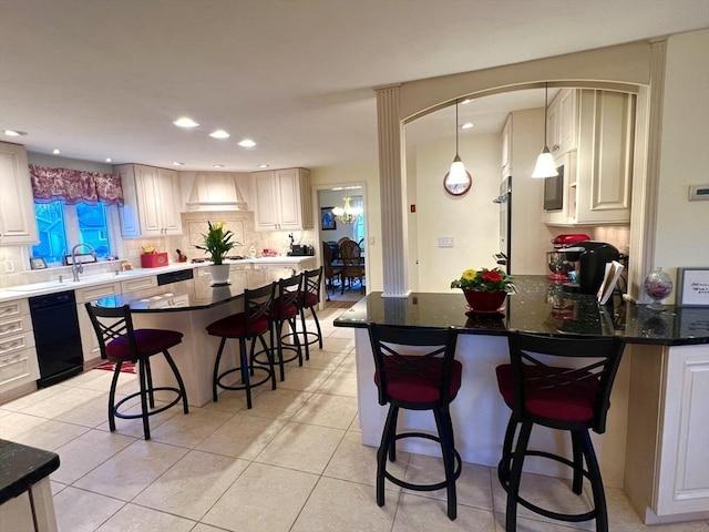 7 Glen Ave, Millbury, MA 01527 - kitchen with decorative backsplash, a breakfast bar area, a peninsula, black dishwasher, and light tile patterned flooring