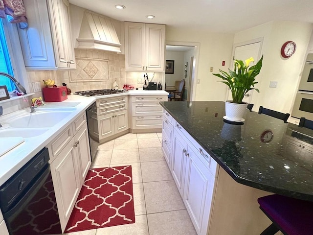 7 Glen Ave, Millbury, MA 01527 - kitchen featuring light tile patterned flooring, appliances with stainless steel finishes, a sink, premium range hood, and decorative backsplash