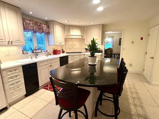 7 Glen Ave, Millbury, MA 01527 - kitchen with decorative backsplash, stainless steel gas cooktop, light tile patterned flooring, a breakfast bar area, and custom range hood