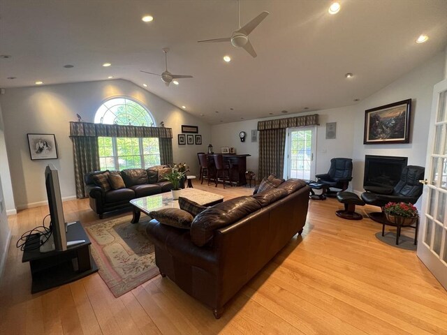7 Glen Ave, Millbury, MA 01527 - living area featuring light wood-type flooring, a ceiling fan, lofted ceiling, and a fireplace