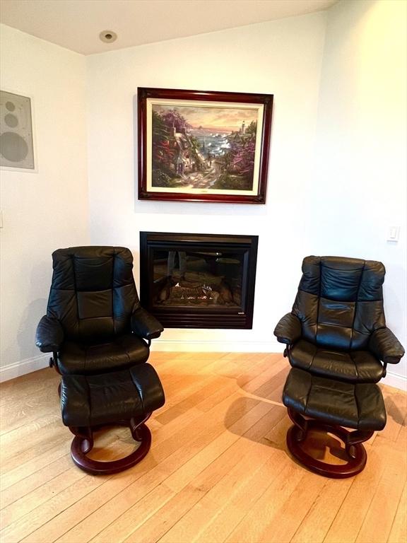 7 Glen Ave, Millbury, MA 01527 - living area featuring a glass covered fireplace, baseboards, and wood-type flooring