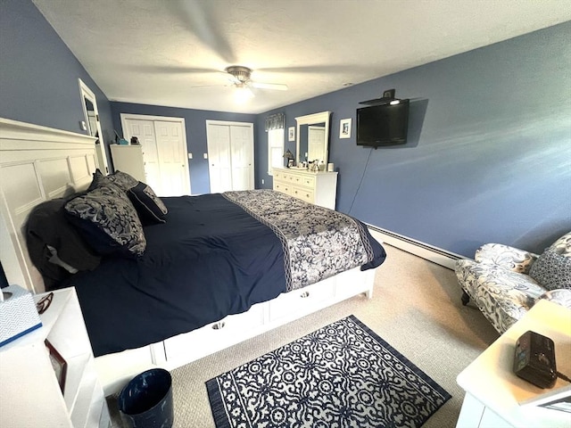 7 Glen Ave, Millbury, MA 01527 - carpeted bedroom featuring wainscoting, ceiling fan, a baseboard heating unit, and two closets