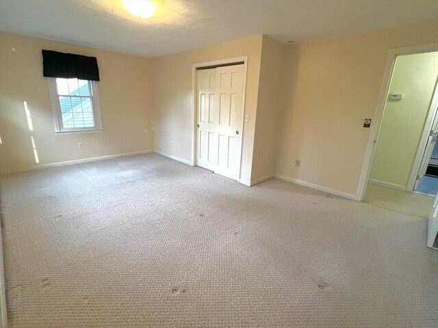 7 Glen Ave, Millbury, MA 01527 - unfurnished bedroom with baseboards, light carpet, and a closet