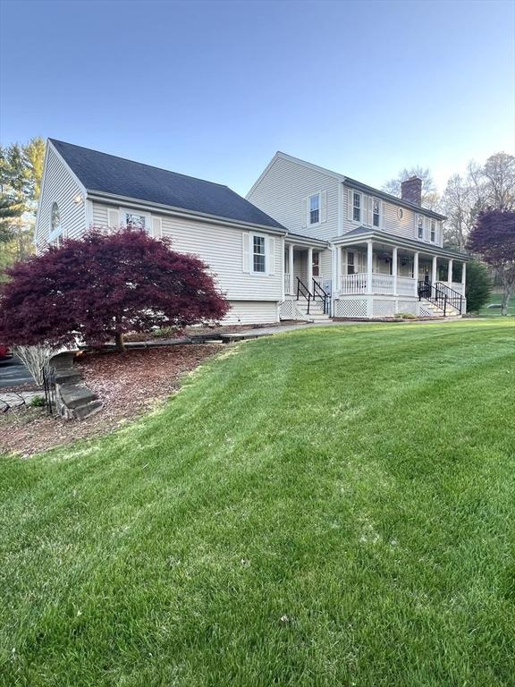 7 Glen Ave, Millbury, MA 01527 - back of house featuring covered porch, a lawn, and a chimney