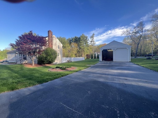 7 Glen Ave, Millbury, MA 01527 - view of home's exterior with an outdoor structure, a garage, a yard, and a chimney