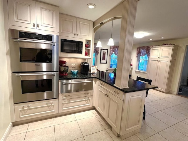7 Glen Ave, Millbury, MA 01527 - kitchen with a peninsula, black microwave, stainless steel double oven, light tile patterned floors, and a warming drawer