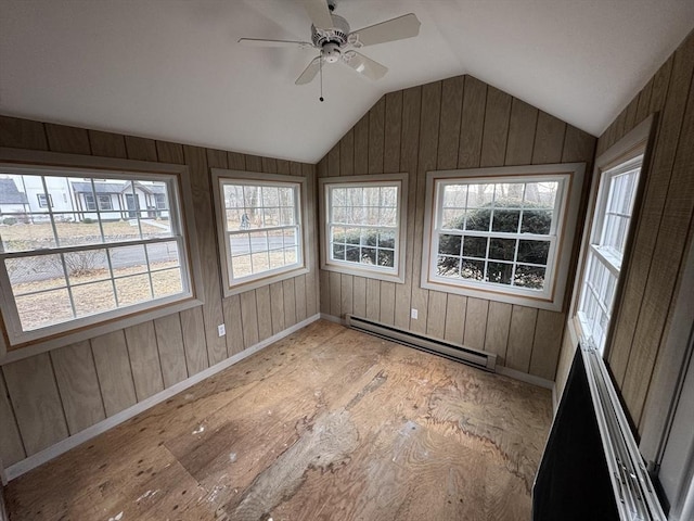 unfurnished sunroom featuring a baseboard heating unit, lofted ceiling, and ceiling fan