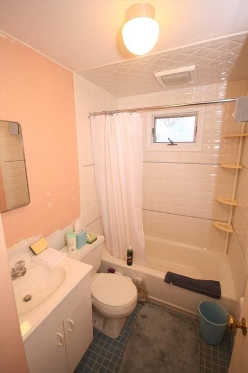 full bathroom featuring vanity, toilet, shower / bathtub combination with curtain, and tile patterned flooring