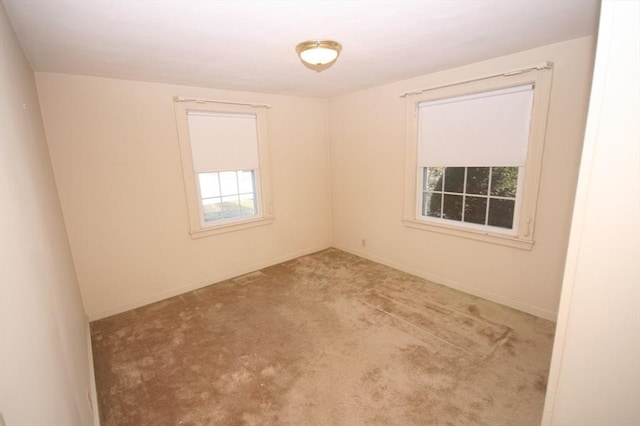 spare room with carpet and baseboards