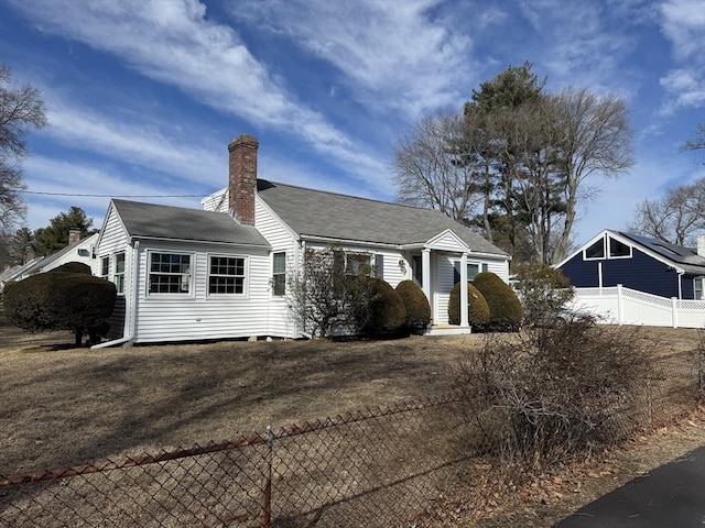 view of front of property featuring a chimney and fence