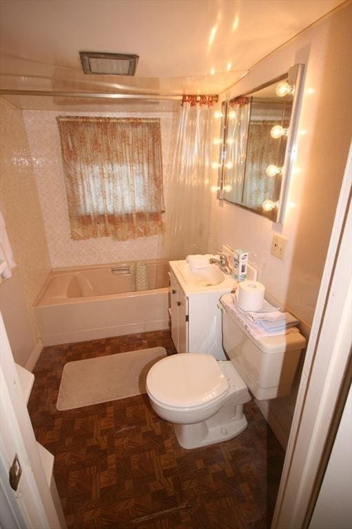 bathroom featuring toilet, shower / washtub combination, and vanity