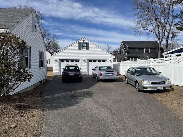 exterior space featuring a garage and fence