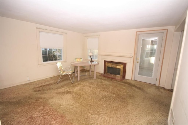 unfurnished living room with a fireplace with flush hearth and carpet flooring