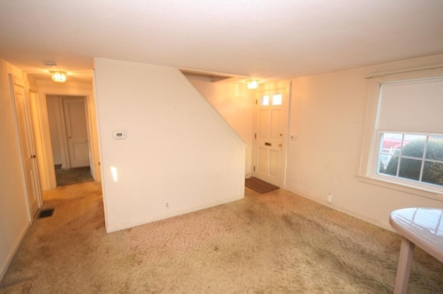 empty room with visible vents and light colored carpet