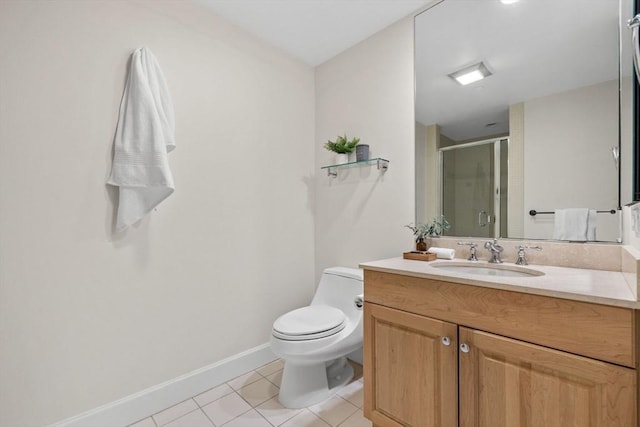 bathroom featuring tile patterned flooring, vanity, a shower with door, and toilet