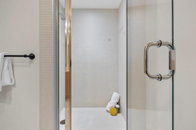 bathroom with a shower with door