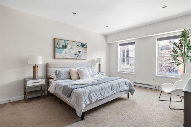 carpeted bedroom with a baseboard heating unit