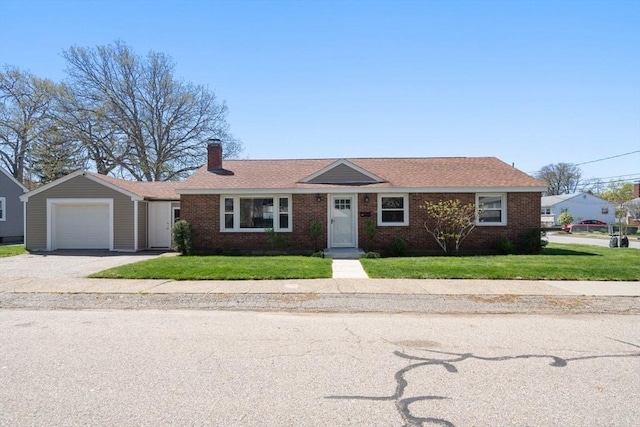 single story home with a front lawn, a chimney, brick siding, an attached garage, and driveway