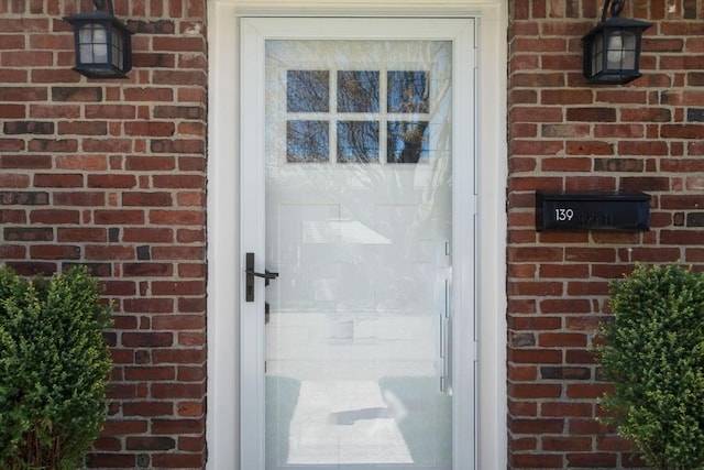 entrance to property with brick siding