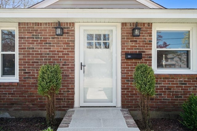 property entrance featuring brick siding