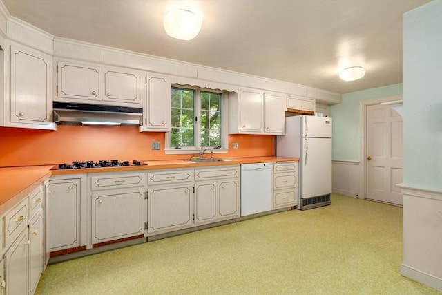 kitchen featuring white appliances, white cabinetry, and sink