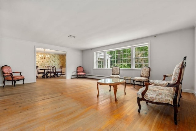 sitting room featuring a chandelier and light hardwood / wood-style floors