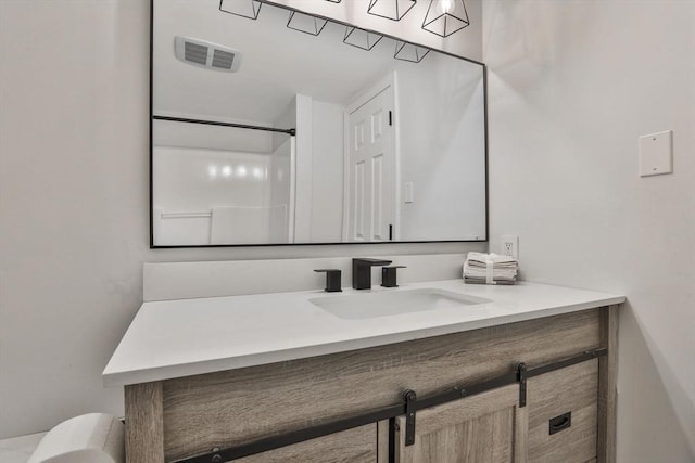 bathroom with a shower and vanity