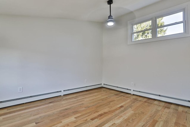 unfurnished room featuring light hardwood / wood-style flooring and baseboard heating