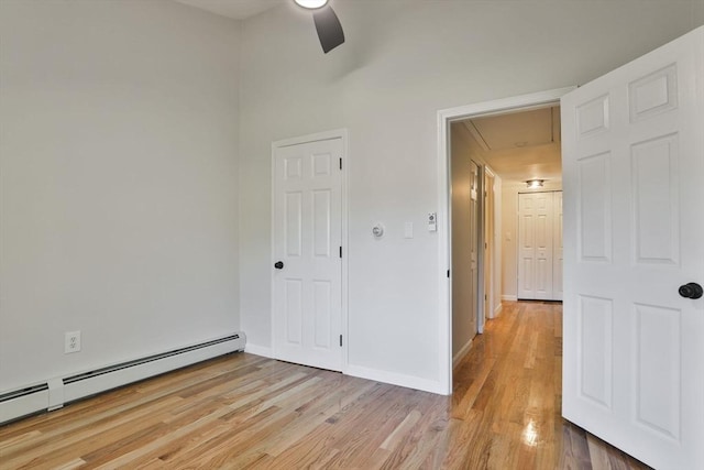 spare room featuring ceiling fan, light hardwood / wood-style flooring, and a baseboard radiator