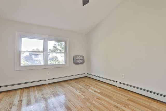 unfurnished room featuring a baseboard heating unit, lofted ceiling, and light wood-type flooring