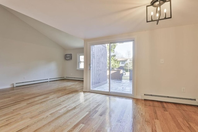 interior space featuring a notable chandelier, light hardwood / wood-style floors, lofted ceiling, and a baseboard heating unit