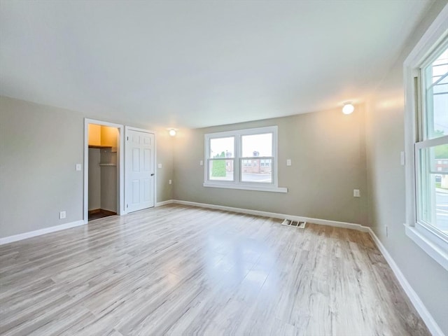 48-50 S Westfield St, Agawam, MA 01030 - unfurnished bedroom featuring light wood finished floors, multiple windows, and baseboards