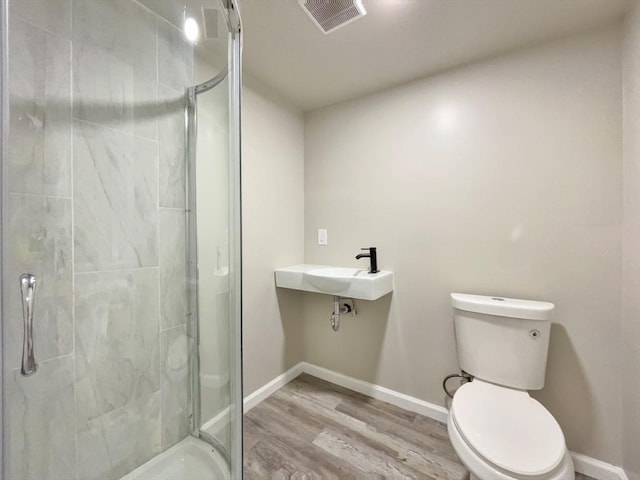 48-50 S Westfield St, Agawam, MA 01030 - full bathroom with wood finished floors, a stall shower, toilet, and baseboards