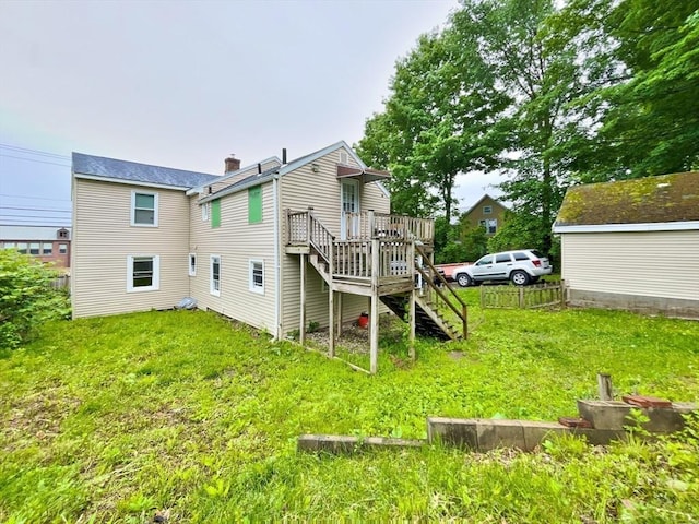 48-50 S Westfield St, Agawam, MA 01030 - rear view of house with a wooden deck, a chimney, a lawn, and stairway