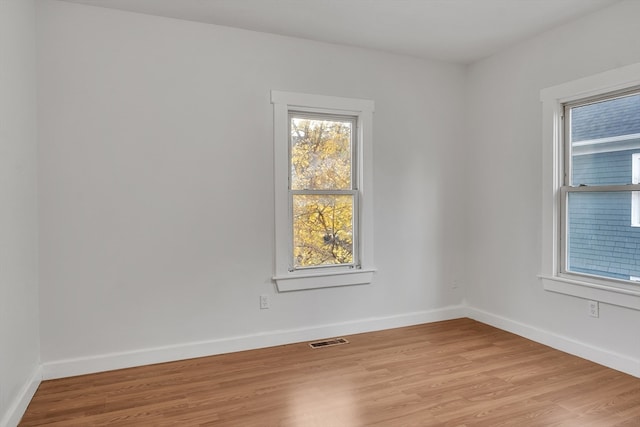 spare room featuring light wood-type flooring