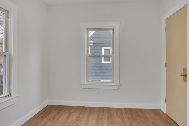 spare room with light hardwood / wood-style floors and a healthy amount of sunlight