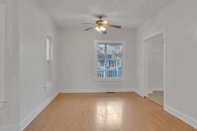 spare room with light wood-type flooring and ceiling fan