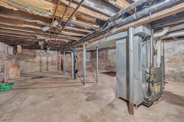 basement featuring electric panel and heating unit