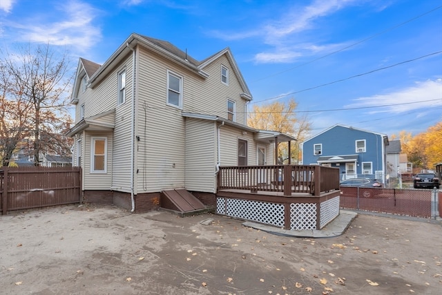 back of property featuring a wooden deck