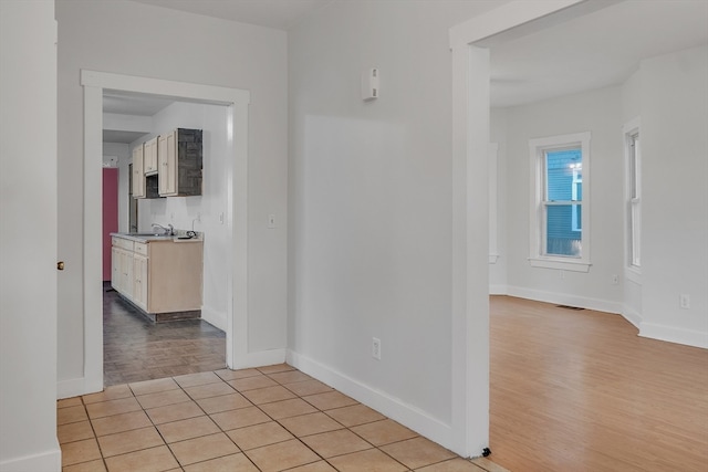 hall featuring light hardwood / wood-style flooring and sink