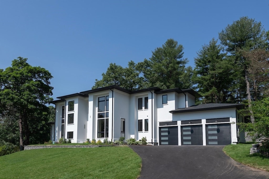 view of front of property with a front yard and a garage