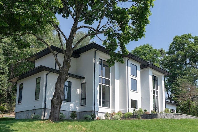 view of property exterior with a lawn