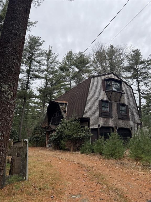 view of property exterior with a gambrel roof