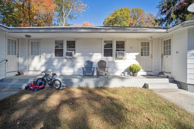 view of front of home with a front yard and cooling unit