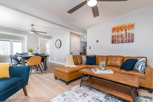 living room featuring ceiling fan and light hardwood / wood-style flooring