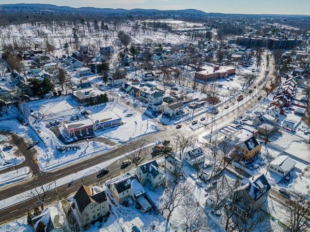 snowy aerial view featuring a mountain view