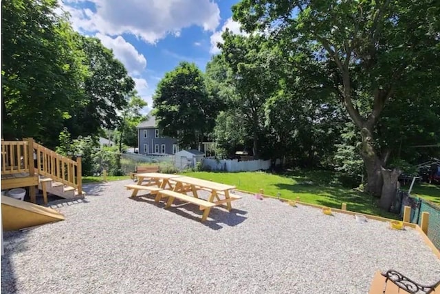 view of yard featuring a patio area and a storage shed