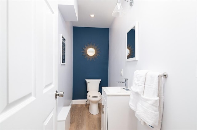 bathroom featuring hardwood / wood-style floors, vanity, and toilet