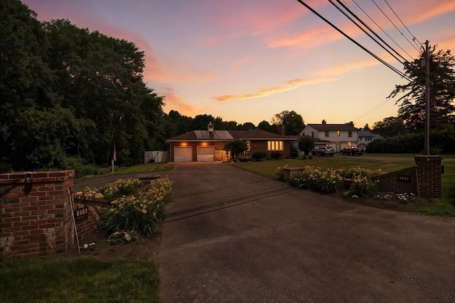 644 Stony Hill Rd, Wilbraham, MA 01095 - view of front facade featuring driveway, a front lawn, an attached garage, and a chimney